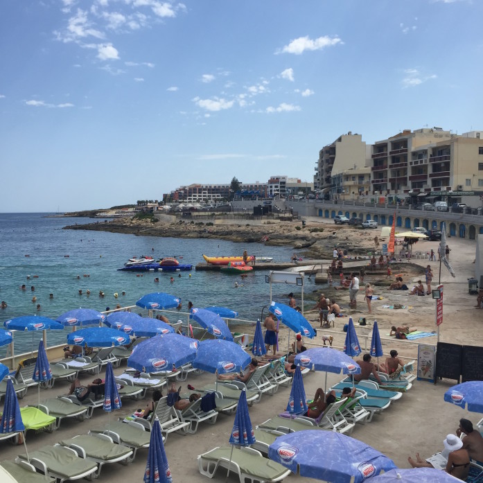 Summer beachgoers in St. Paul's Bay