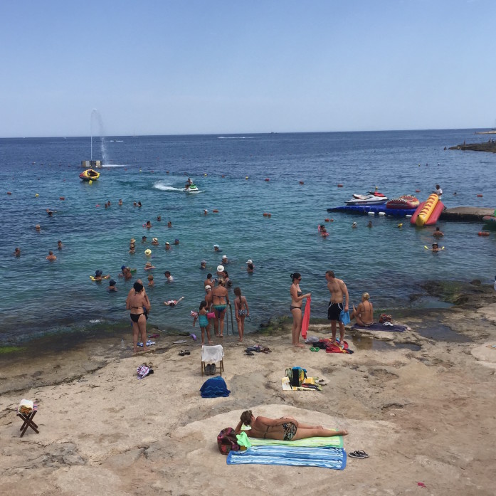 Summer beachgoers in St. Paul's Bay